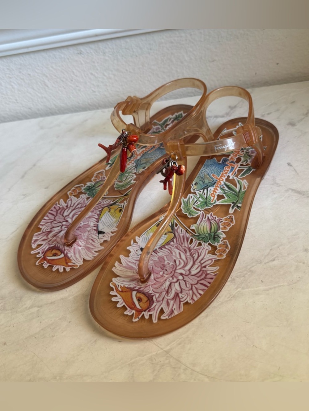 Salvatore Ferragamo Amber Jelly T-Strap Sandals with Red Coral Charm Cluster